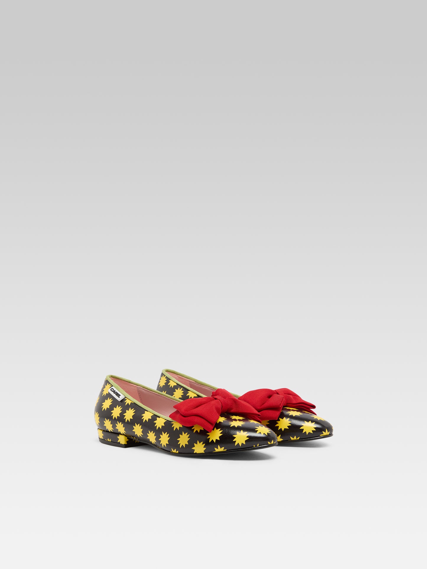 Star M - Black leather ballet flats with yellow stars and a red bow