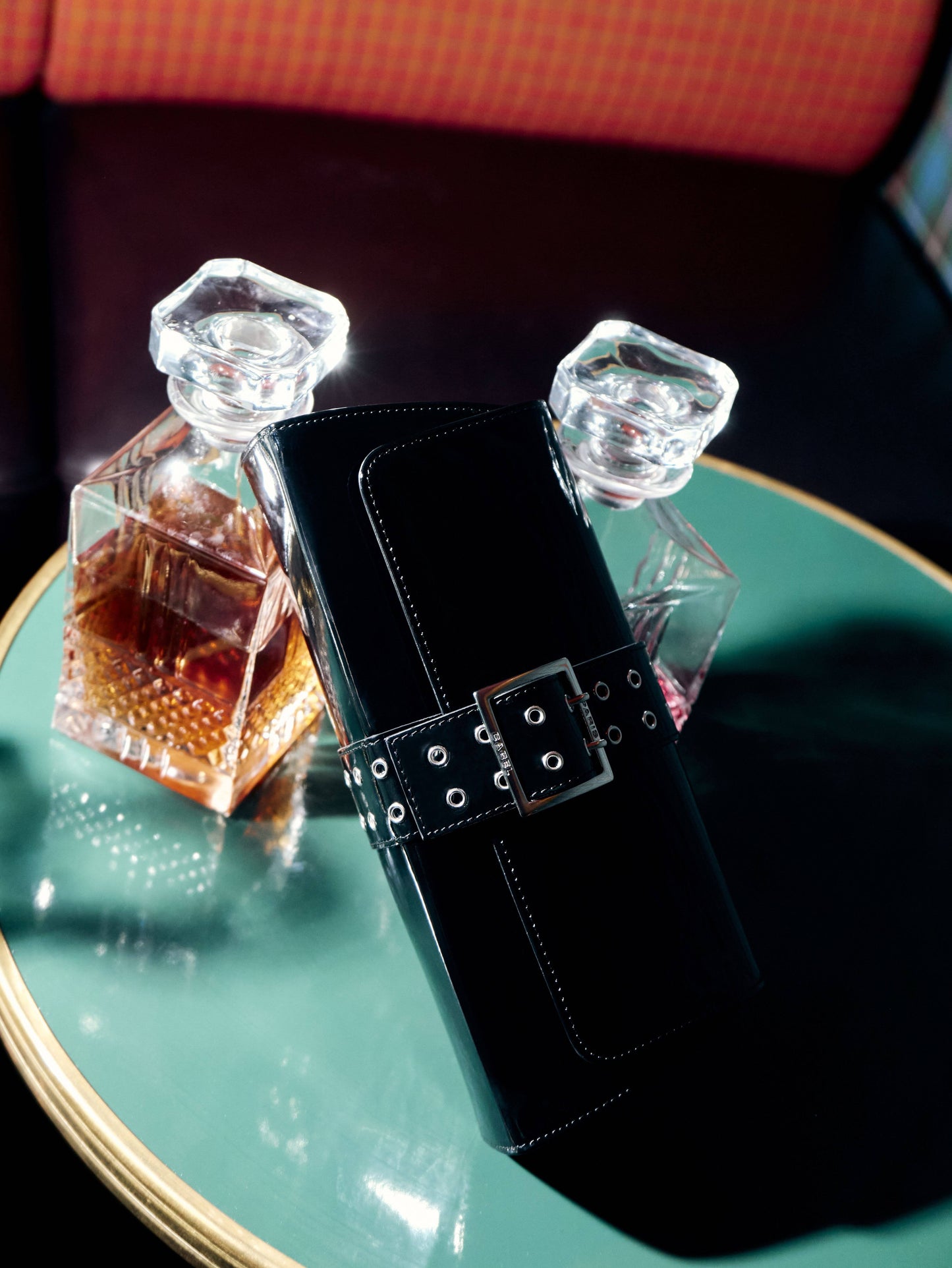 Maddie - Black patent leather shoulder bag with eyelets