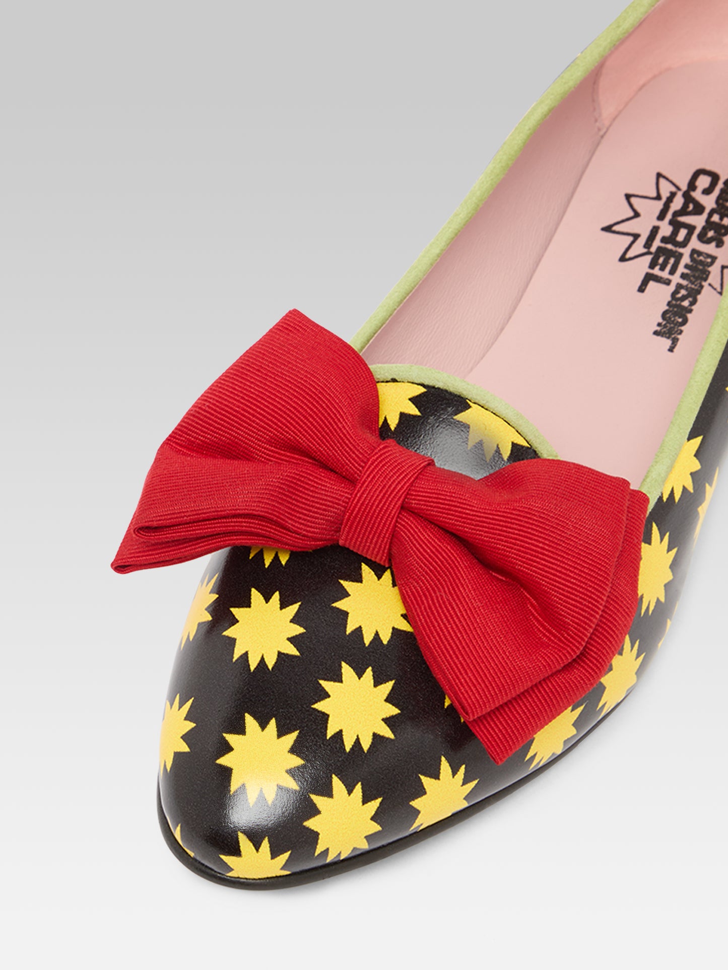 Star M - Black leather ballet flats with yellow stars and a red bow