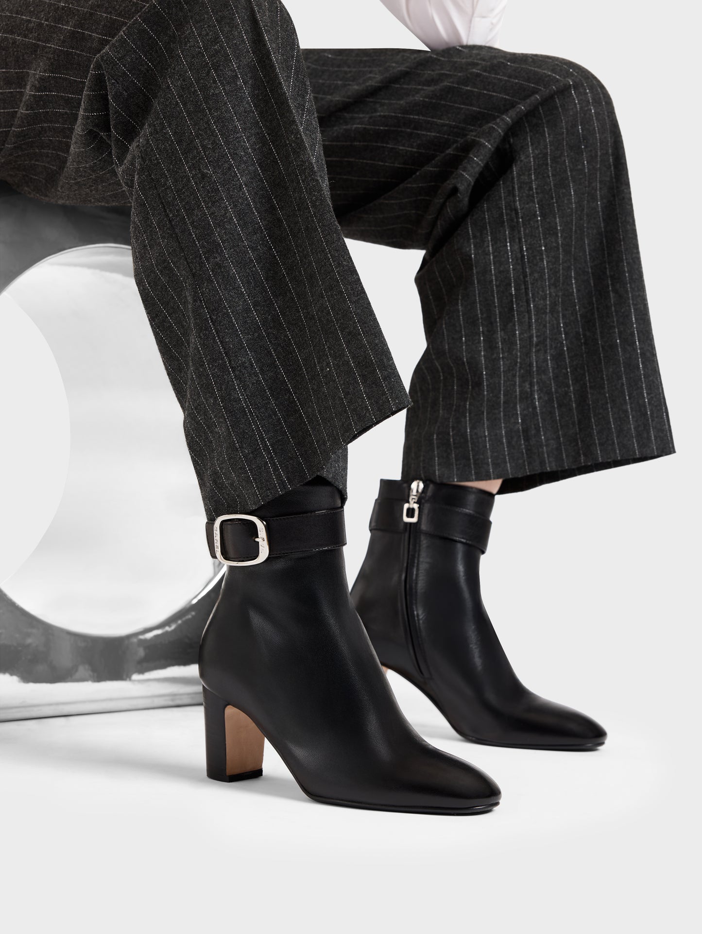 Thelma - Black leather ankle boots with buckle